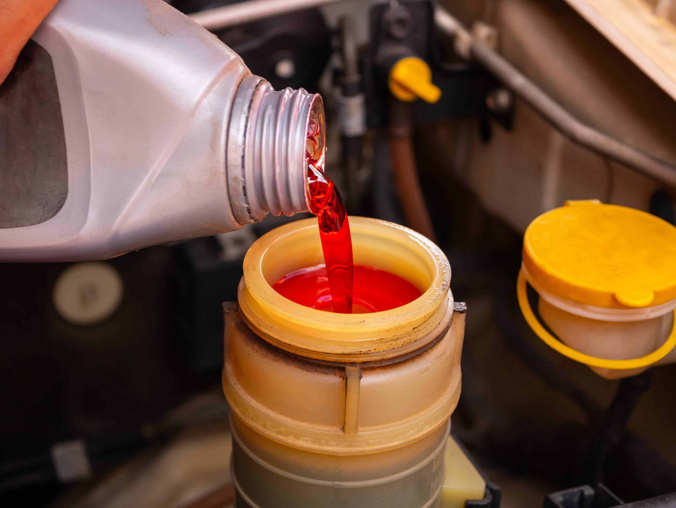 Add brake fluid to the car engine. Brake Fluid Exchange